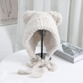 Detailed texture of plush cream knit hat with bear ears and warm chin straps - One Size / Beige