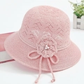 Detail of pink crochet sun hat featuring woven floral accents and faux pearl beads - One Size / Pink