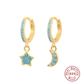Detailed close-up of S925 sterling silver gold hoops with blue star and moon charms - Gold - Turquoise