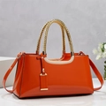 Close-up of shiny orange patent leather texture and gold woven handle on handbag - Orange / 34*11*16CM