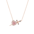 Macro detail of Cupid heart pendant with pink gems and rose gold needle motif - Necklace / Rose Gold