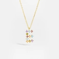 Macro detail of gold necklace with letter E pendant and multi-colored cubic zirconia - Gold E