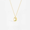 Detail of gold oval pendant with colorful gemstones and letter J on a gold chain - Libra