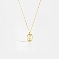 Macro detail of gold constellation pendant with multicolor gems and branch motif - Scorpio