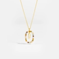Macro detail of 925 silver gold-plated pendant featuring letter D and colorful zircons - Letter D