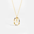 Detailed macro view of 925 silver gold necklace with colorful zircon K initial pendant - Letter K