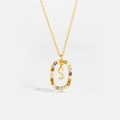 Close-up of golden letter S necklace with multi-color zircon stones and fine chain - Letter S