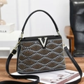 Elegant black PU leather handbag featuring wave pattern metallic studs and V-shape metal logo - Black