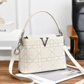 Beige crossbody handbag with crystal grid pattern and metal V logo on wooden table - White