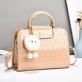Beige patent leather quilted handbag with metal ring handles and plush ball charm - Khaki