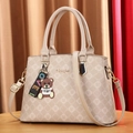 Fashionable beige tote bag with letter print and cartoon bear charm on wooden surface - Large Bag / Milk Tea