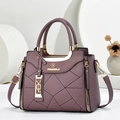 Dettaglio della borsa viola con cuciture geometriche e targhetta logo dorata - 23.5*9*19 / Viola
