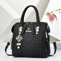 Elegant black faux leather Boston handbag with pearl pendant and gold metal hardware - Black