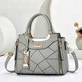 Elegant grey pebble leather handbag with gold hardware and stylish geometric stitching - Gray