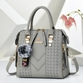 Gray faux leather crossbody bag with V-quilted pattern and fluffy pompom charm - Gray