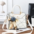 Detail of white tote bag showing lychee grain leather, grid stitching and fur ball charm - 23.5cm x 9cm x 19cm (11cm Handle) / Off White