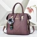 Dark mauve faux leather handbag featuring woven texture and a fluffy tricolor pompom - Purple