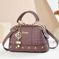 Elegant purple leather handbag with pearl charm and woven texture on a minimalist base - 25*13*15 / Purple