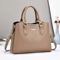 Detail of khaki pebbled leather handbag featuring gold hardware and logo branding - Light Khaki