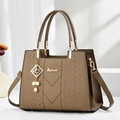 Brown lychee leather handbag with golden hardware and pearl charm on white stand - Quilted Style / Khaki