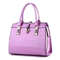 Detailed view of lilac crocodile embossed faux leather handbag with gold metal clasp - Purple