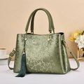 Elegant sage green women's handbag with embossed floral pattern and tassel charm - 28cmx13cmx19cm / Green