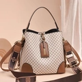 Close-up of stylish plaid bucket bag with brown leather trim and wide patterned shoulder strap - Style 3 Argyle Khaki