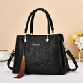 Elegant black handbag with embossed floral pattern and tassel charm, large capacity - 28cmx13cmx19cm / Black