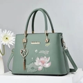 Elegant sage green handbag with lotus embroidery and heart tassel charm detail - Green