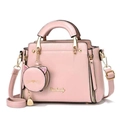 Detailed view of pink textured faux leather handbag with cat-shaped coin purse and gold logo - Pink