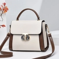 Vintage cream and brown leather mini bag with gold letter clasp and top handle on white stand - Off White
