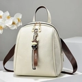 Minimalist cream soft leather backpack for women with dark brown straps and cow charm - Off White