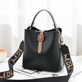 Fashionable black leather bucket bag with brown handles and patterned wide shoulder strap - Black