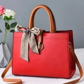 Elegant red fashion handbag with brown handles and a stylish patterned scarf accent - 30x13x22cm / Red