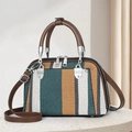 Detail of woven striped handbag with brown leather straps and silver hardware accents - Green (Emerald Ginger Beige Stripes)