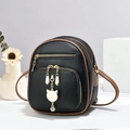 Detail of black pebbled leather mini bag with gold cat charm and contrast brown trim - 16*9*20 / Black