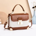 Detail of classic square handbag featuring brown and white leather with gold twist lock - Brown and White Brand Embossed (Style 3) / 20x8x15