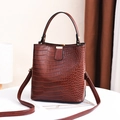 Brown crocodile texture bucket bag with top handle and adjustable crossbody strap - Brown