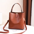 Dark brown faux crocodile texture bucket bag with top handle and gold metal hardware - Earthy Yellow