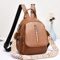 Detailed view of brown lychee-patterned PU backpack with decorative side metal zipper - Earthy Yellow