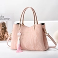 Pink textured leather handbag with gold lettering and gradient tassel accessory - Pink