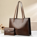Detail of vintage brown PU leather tote bag set with matching envelope pouch on counter - 36x14x26 / Coffee