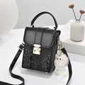 Black snake pattern crossbody phone bag with gold lock and cute plush monster charm - Black