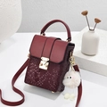 Burgundy snake pattern crossbody bag with gold buckle and white plush charm - Burgundy
