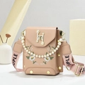 Detail of embroidered daisy on pink crossbody phone bag with pearl handle and wide strap - Khaki