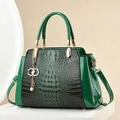 Elegant green crocodile pattern handbag with gold hardware and pearl pendant detail - Green