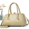 Detail of beige lychee textured handbag with elegant gold hardware and teardrop accents - 29*14*16 / Green