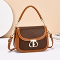 Elegant camel handbag with woven flap and gold CD buckle shown in a modern interior setting - Khaki & Brown
