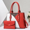 Detailed shot of a two-piece red and white tote set with leopard accent and rivets - Red