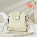Chic beige lychee leather bucket bag with unique wave edge and silver U-shaped buckle - White